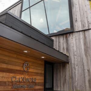 An architectural shot of the front entrance of the school with gym windows.