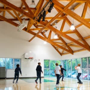 Children playing basketball in the gym.