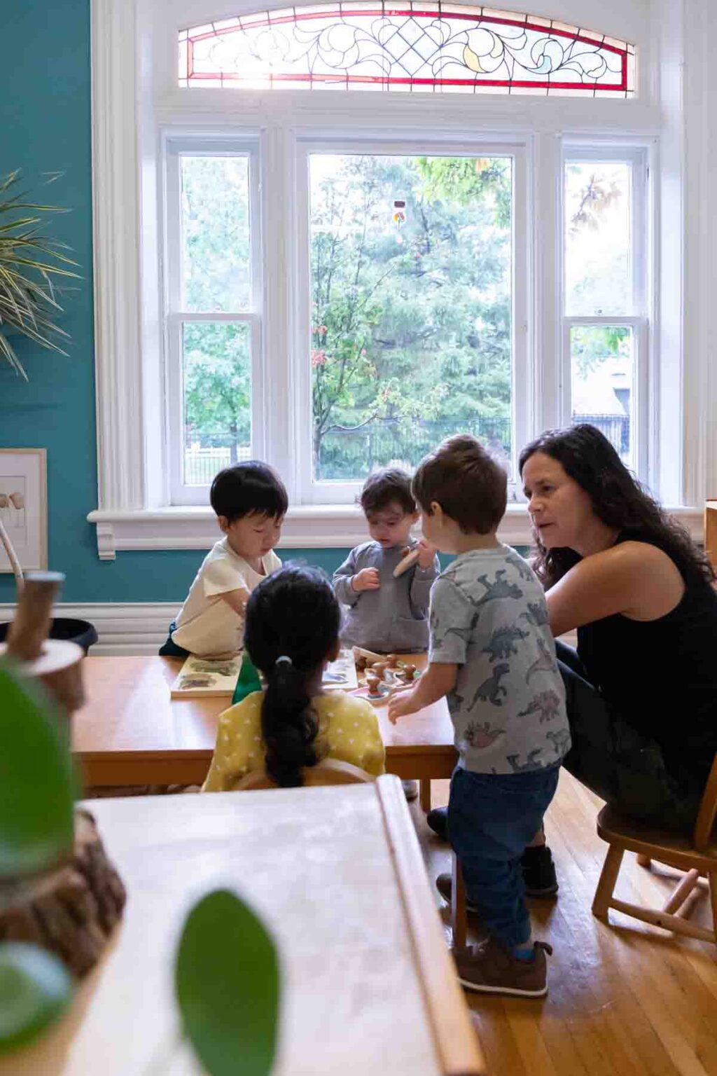 Toddler children in the classroom with their teacher.