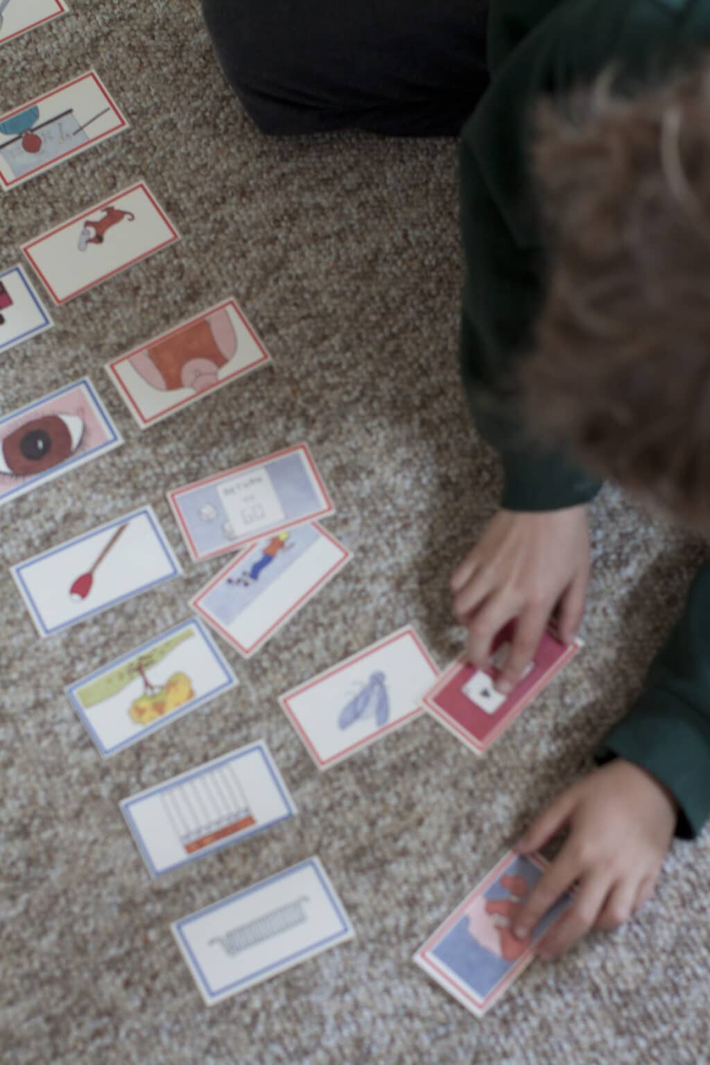A view of a Casa child's hands, working with language materials.