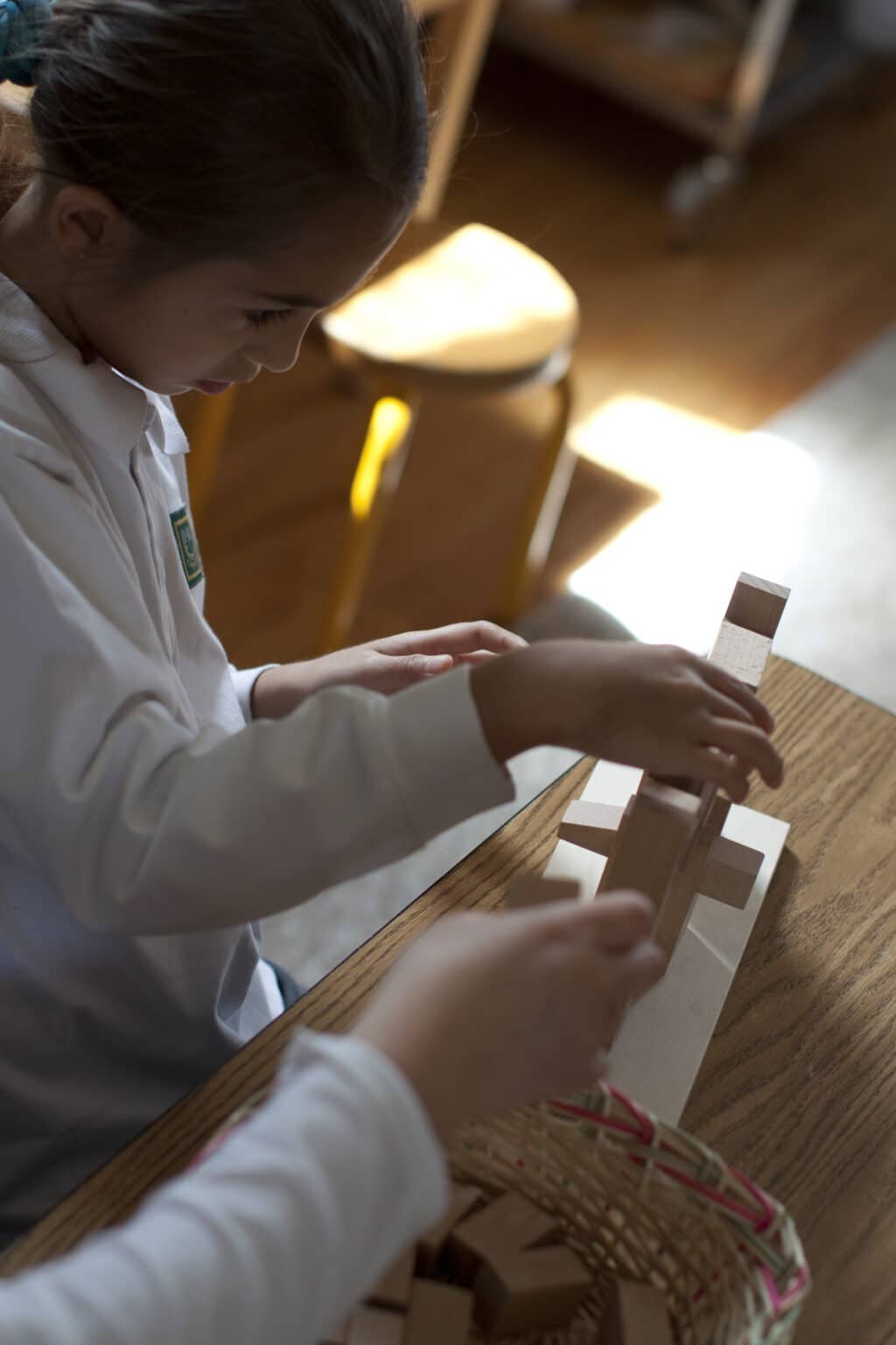 Elementary children working together to build the Roman Arch, part of the Montessori sensorial materials.