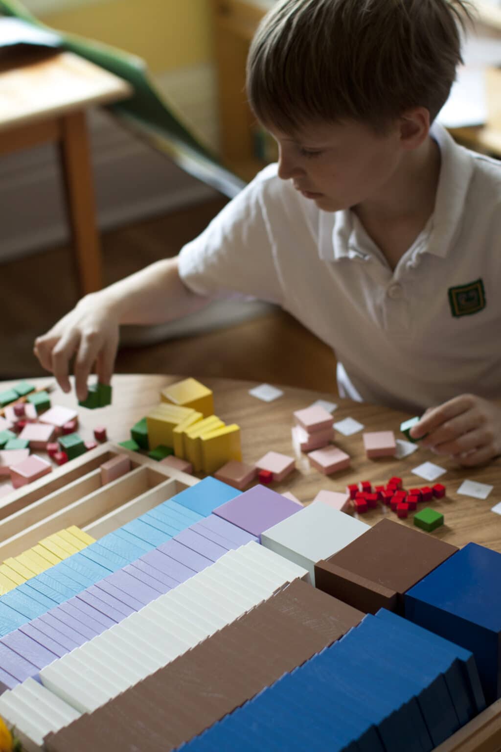 An Elementary child works with materials representing the Pythagorean Theorem.