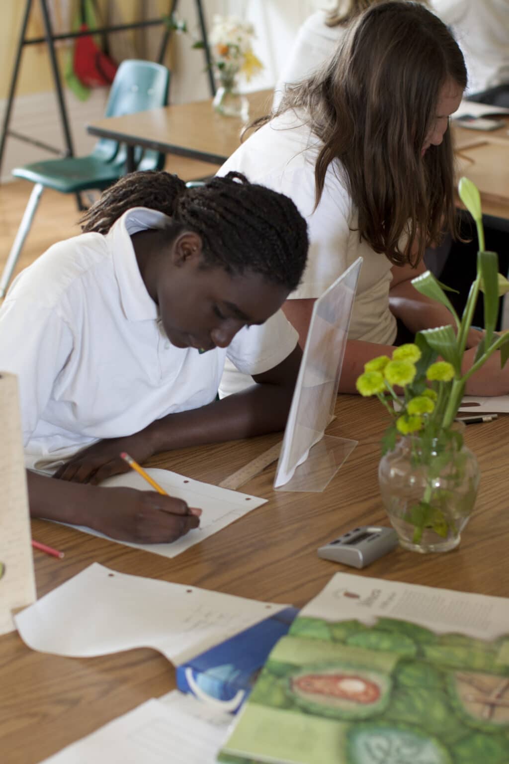 Two Elementary children working diligently on a project.