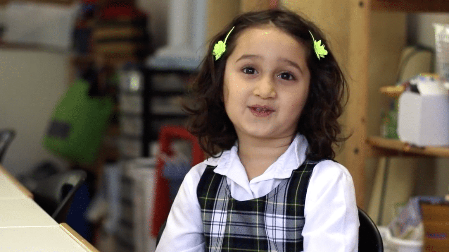 A Casa child, sporting two lovely hair clips.